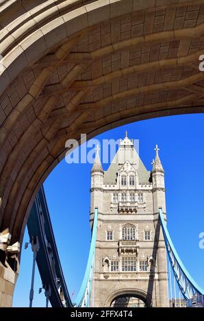 London, England, United Kingdom. One of the iconic Tower Bridge's two towers as seen through the southern Southwark entry portal leading to the bridge. Stock Photo