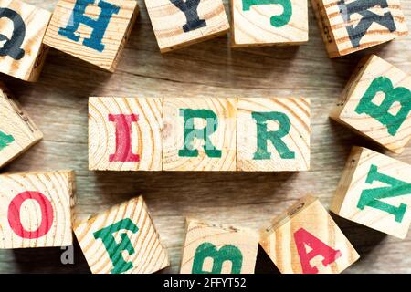 Alphabet letter block in word IRR (Abbreviation of internal rate of return) with another on wood background Stock Photo