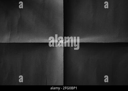 Black paper folded in four fraction background Stock Photo