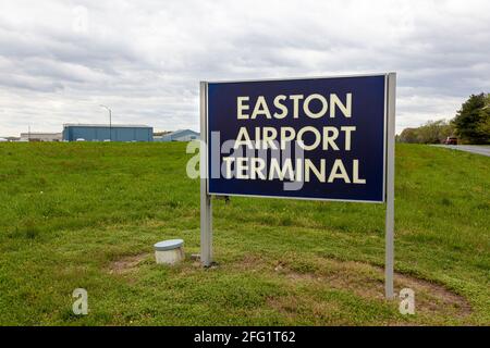 Easton, MD, USA 04-16-2021: Image  of the sign of Easton Airport (ESN) owned by Talbot County for public use. Image shows, hangars, and terminal from Stock Photo