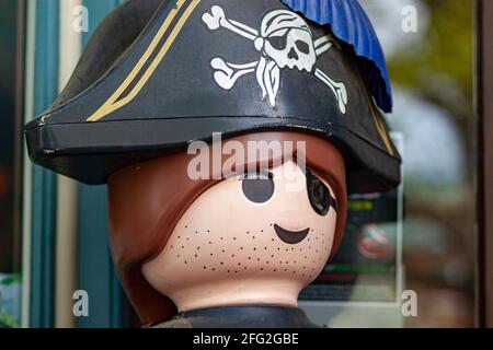 Close up image of a pirate toy figure at display in front of a shop selling children toys. Concept image for creativity, child development, fantasy, r Stock Photo