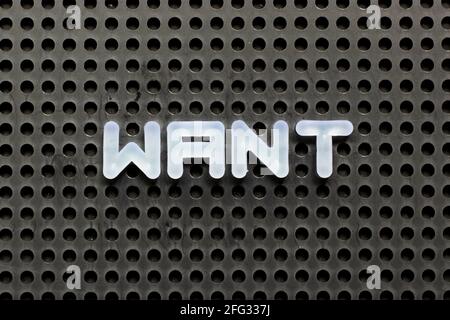 White color letter in word want on black pegboard background Stock Photo