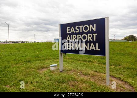 Easton, MD, USA 04-16-2021: Image  of the sign of Easton Airport (ESN) owned by Talbot County for public use. Image shows, hangars, and terminal from Stock Photo