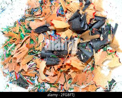 Shavings after watercolour pencils have been sharpened, including black shaving from an eye makeup pencil Stock Photo
