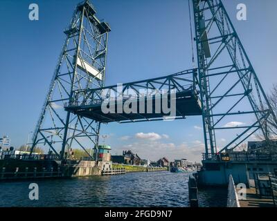 Opened lift bridge over canalized river 'Gouwe' in Waddinxveen, near the city of Gouda, The Netherlands. Stock Photo