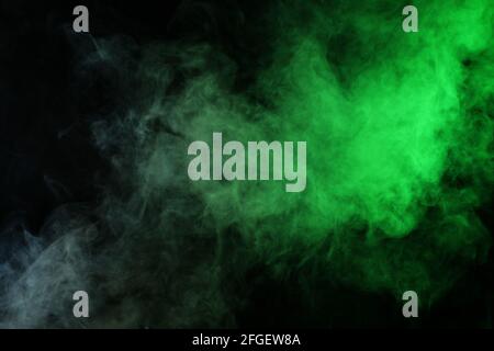 Smoke in red-green light on black background Stock Photo