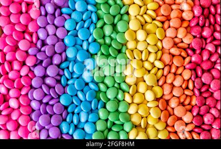 Vibrant sweet rainbow made of multi-colored round candies Stock Photo
