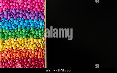 Vibrant sweet rainbow made of multi-colored round candies Stock Photo