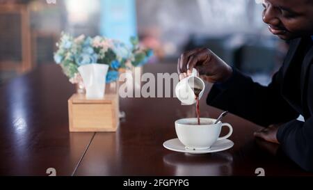 African businessman making hot coffee with smile and happy Stock Photo