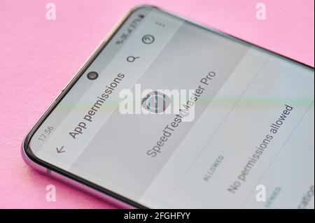 New york, USA - April 23, 2021: Changing permissions setting of speedtest app on smartphone screen macro close up view Stock Photo