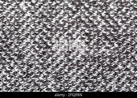 Black and white colored woven synthetic material rough structure macro, extreme closeup, abstract grey textile surface, top view, simple background te Stock Photo