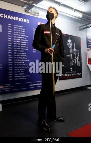 Judd Trump of England wears a face mask as he waits to walk out to the table prior to the Betfred World Snooker Championship Round Two match between David Gilbert of England and Judd Trump of England during day nine of the Betfred World Snooker Championships 2021 at The Crucible, Sheffield. Picture date: Sunday April 25, 2021. Stock Photo