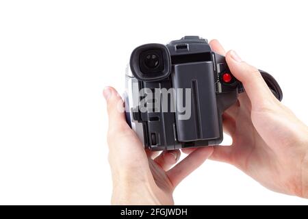 Man holding a simple film camcorder device in hands, old portable movie camera, first person pov recording video fp point of view, isolated on white b Stock Photo