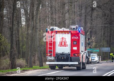 Warsaw, Poland - April 20, 2021: Fire truck on the road. Rescue operation after a car accident. Stock Photo