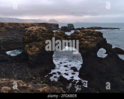 Beautiful view of famous natural arch Gatklettur formed of volcanic basalt rocks on the rough Atlantic coast of Arnarstapi, Snæfellsnes, Iceland. Stock Photo