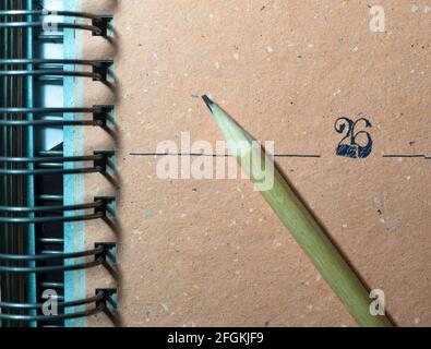 pencil on a colored page of an agenda or diary made with recycled ecological paper Stock Photo