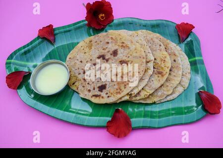 Indian special dish Bobbatlu or Bhakshalu a telugu sweets for Ugadi festival special food. Sweet chapati flat bread jaggery and lentils served with pu Stock Photo