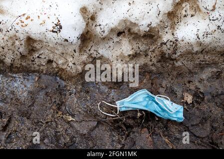 Photo of throwed used medical mask on the ground Stock Photo