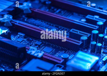 LOS ANGELES, USA 25 APRIL 2021: Pcie slot detail n a motherboard of a gaming pc in a blue light Stock Photo