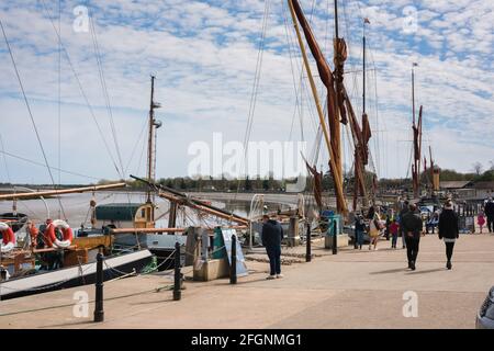 Hythe Quay Maldon, view of people walking beside barges along the waterfront at Hythe Quay in the Essex town of Maldon, England, UK. Stock Photo
