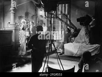 LILIAN HARVEY (back to camera) and WILLY FRITSCH on set candid with Movie Crew during filming of EINBRECHER aka MURDER FOR SALE 1930 director HANNS SCHWARZ producer Erich Pommer Universum Film (UFA) Stock Photo