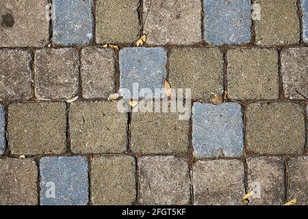 Background texture of bricks in blue, brown and grey colors. Stock Photo
