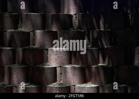 Background texture of dark red bricks with the piece of light on them Stock Photo