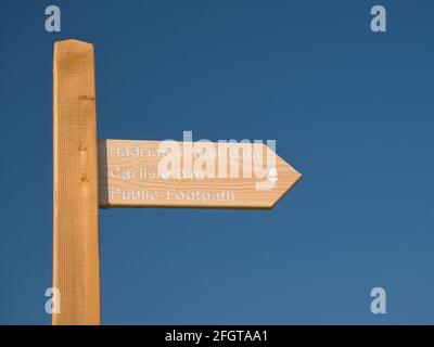 A new wooden sign post on the Hadrian's Wall Path on the Solway Coast, Cumbria, UK, 3 miles from Carlisle, isolated against a clear blue sky with no c Stock Photo