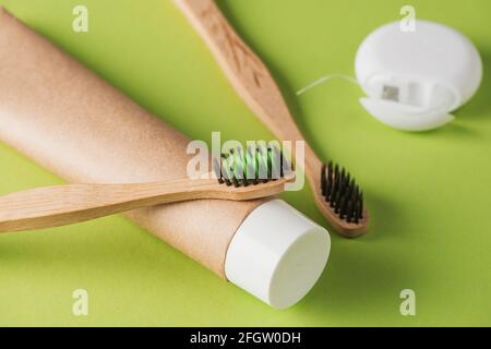 Close-up on toothpaste, bamboo toothbrushes and dental floss Stock Photo