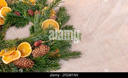 Wide banner with natural spruce wreath on a fabric tablecloth Stock Photo