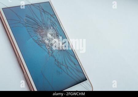 Phone with broken glass close-up. Concept phone repair Stock Photo