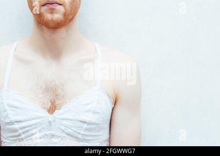 young handsome homosexual man wearing womens bra, isolated on white Stock  Photo
