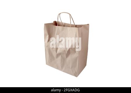 Shopping brown kraft paper bag with handles isolated on white. Stock Photo