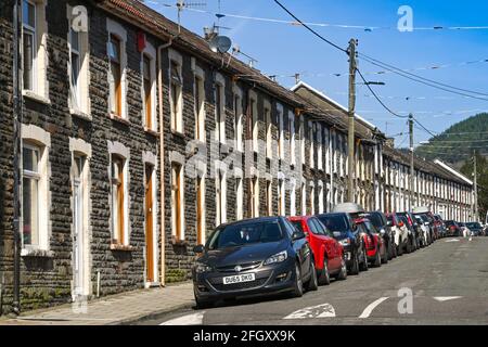 Tonypandy, Rhondda valley, Wales - April 2021: Traditional terraced homes with cars parked outside on a street in Tonypandy in the Rhondda valley Stock Photo