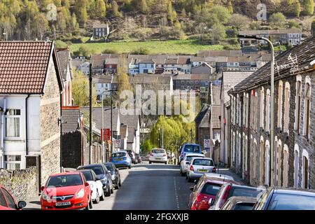 Tonypandy, Rhondda valley, Wales - April 2021: Traditional terraced homes on a steep hill in a street in Tonypandy in the Rhondda valley Stock Photo