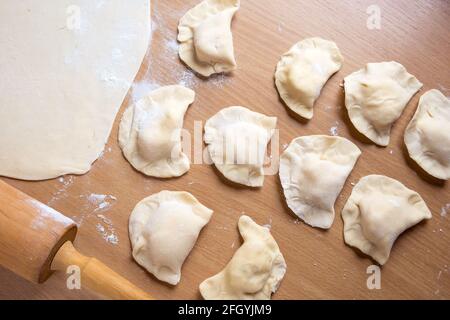 Raw dumplings on a board. Traditional homemade food Stock Photo