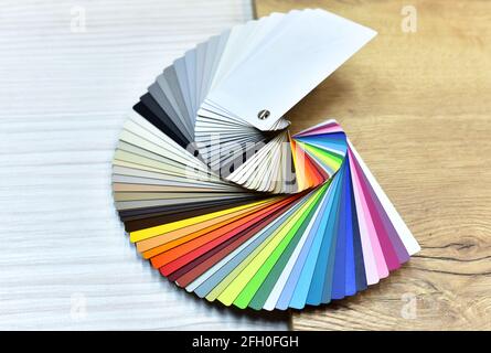 Color palette swatches. Palette of different colors and shades on wood background. Color catalog for tinting facade and interior paints, printing and Stock Photo