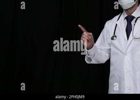 Doctor with stethoscope on black background Stock Photo