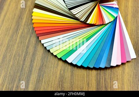 Color palette swatches. Palette of different colors and shades on wood background. Color catalog for tinting facade and interior paints, printing and Stock Photo