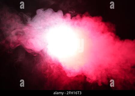 Smoke in red light on black background Stock Photo