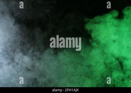 Smoke in red-green light on black background Stock Photo