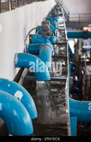 Water purification station. Low depth of field. Blue pipes and flow water. Aeration and filtration. Kyzylorda, Kazakhstan Stock Photo