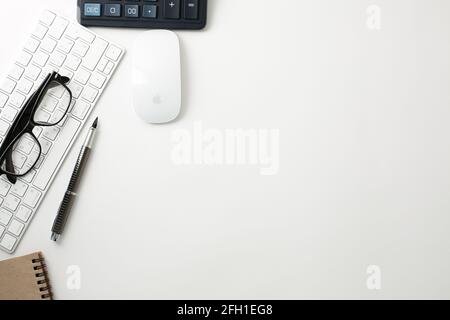 Office workplace with keyboard mouse glasses pen and calculator on white background Stock Photo