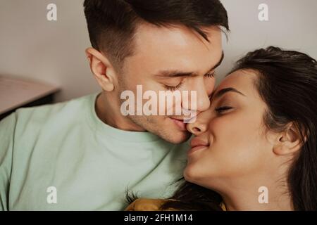 Lovely young couple showing romantic feeling to each other, close up. Happy family moving to new apartment Stock Photo