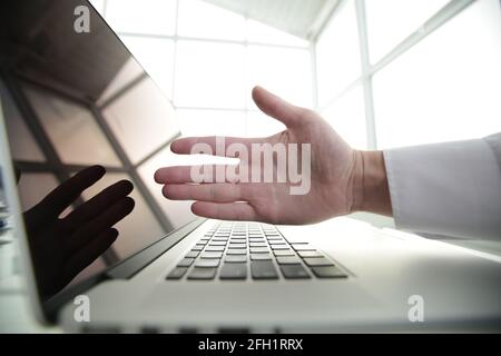 Concentrated young male professional wearing breath protective mask, working on computer after washing hands with antiseptic liquid, preventing Stock Photo