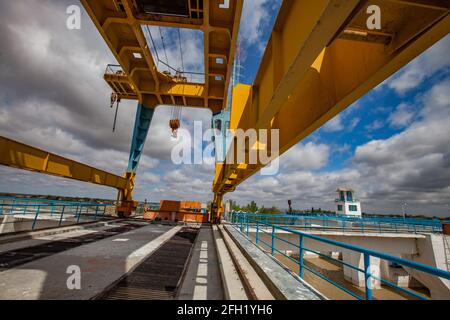 Close up photo of gentry crane for water shutter lifting. Shardara river dam. blue sky, clouds. Kazaly city, Kyzylorda region, Kazakhstan. Stock Photo