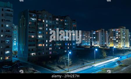 Aerial Flying low over modern town with illuminated park views at the night  Stock Photo