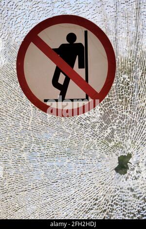 Broken window and warning sign in the train Stock Photo