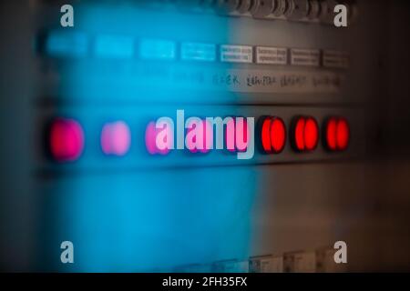 Moinak hydroelectric power station. Blue control panel. Red indicator lamps. Low depth of field, partially blurred. Stock Photo