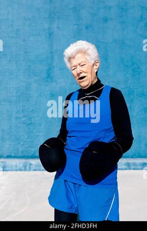 Cheerful mature woman looking at camera through hand finger heart Stock ...